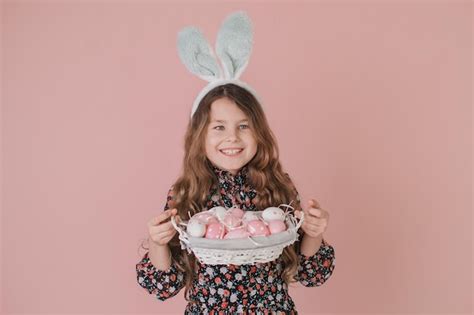 Premium Photo Girl With Bunny Ears Holding An Easter Basket