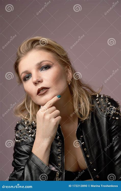 Woman Blonde In Leather Jacket Looking At Camera Isolated In Studio