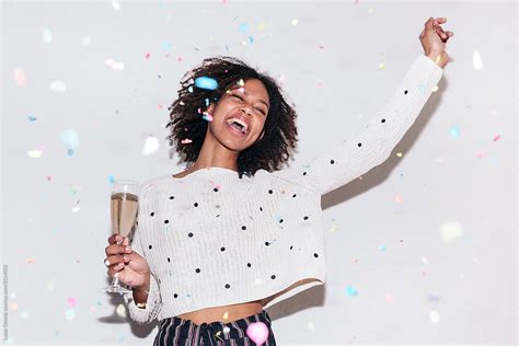 Multiracial Woman Celebrating A Party With A Glass Of Champagne By