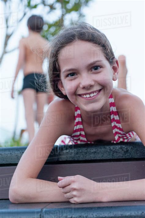 Girl In Bikini Lying On Stomach Portrait Stock Photo Dissolve