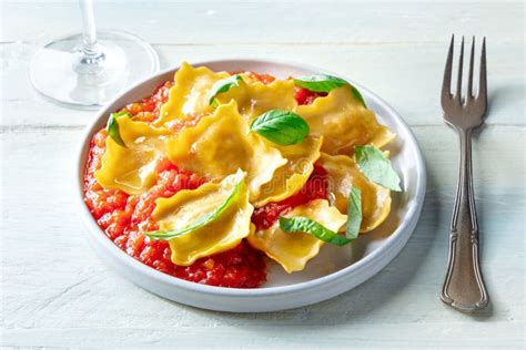 Ravioli With Tomato Sauce And Fresh Basil Leaves On A Plate Italian