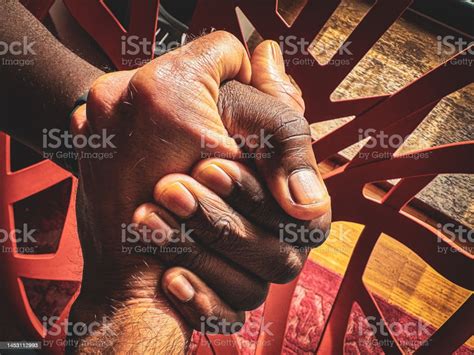 Image Of A Interracial Handshake Between Two Hands Stock Photo