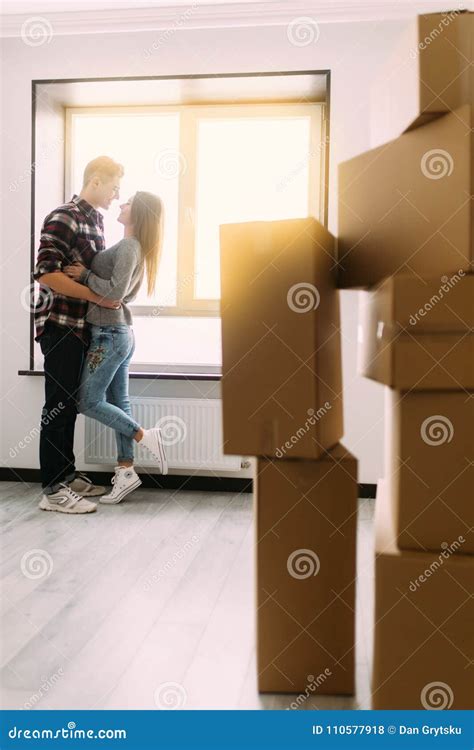 Full Length Portrait Of Beautiful Young Couple Hugging And Smiling