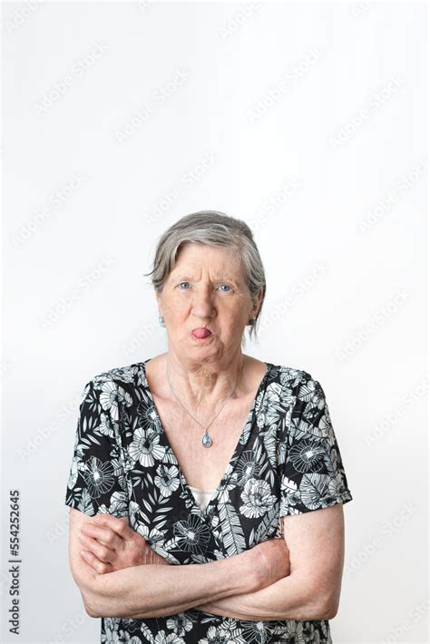 Old Senior Grey Haired Woman Doing Mocking Gesture While Sticking Out