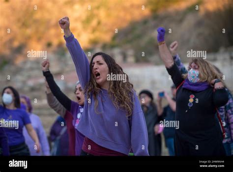 A Woman Seen Rising Her Fist As She Takes Part In A Feminist Flashmob