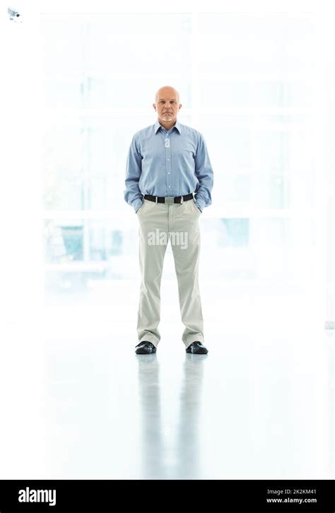 man standing with hands in pockets Stock Photo - Alamy