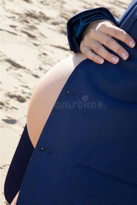 Young Pretty Beauty Belly Pregnant Woman In Man Blue Jacket Standing On Sand Beach Stock Image