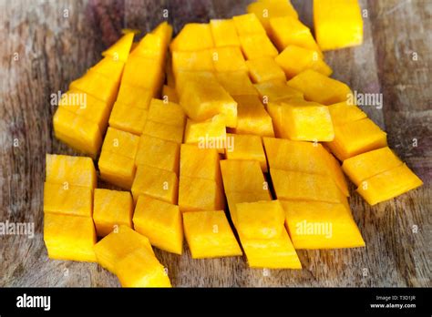 Cut Into Cubic Pieces Of Ripe Yellow Pumpkin Pulp While Cooking In The