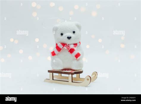 White Polar Bear Toy With Scarf On The Sledge On A White Background