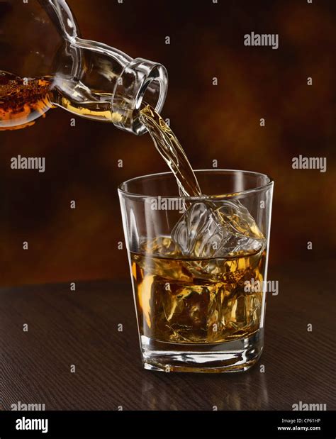 Close Up Of Whiskey Being Poured Into A Glass Hi Res Stock Photography