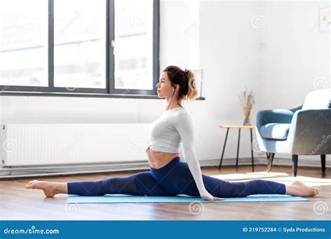 Young Woman Doing Splits Yoga Pose At Studio Stock Photo Image Of