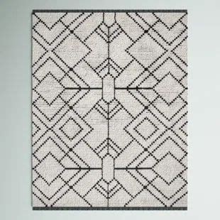 a black and white rug with an intricate design on the front, hanging ...