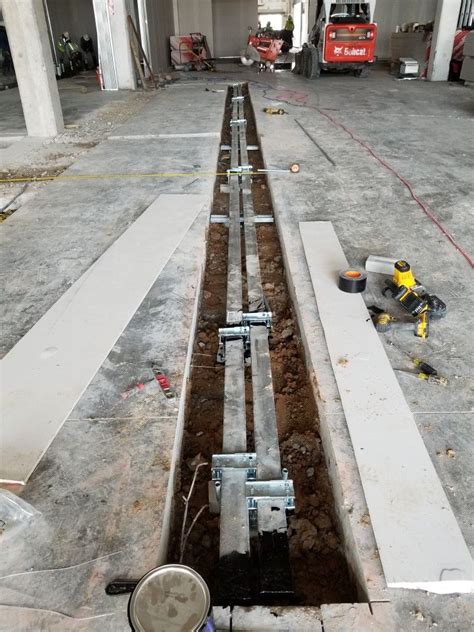 Install and secure wiremold walkerduct for under concrete electrical runs Levcor inc. Washington ...