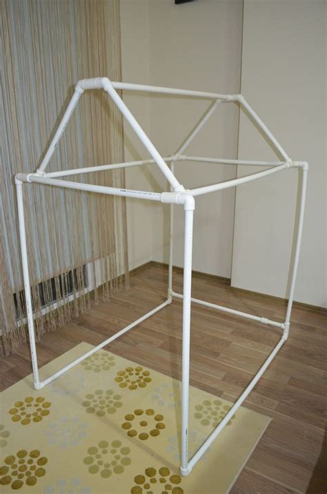 A White Metal Structure Sitting On Top Of A Wooden Floor Next To A Rug