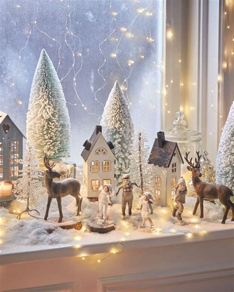 A Window Sill Filled With Christmas Decorations And Figurines On Top Of