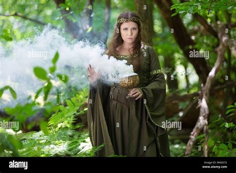 Elf Performing Spells In The Forest With Magical Smoke Stock Photo Alamy