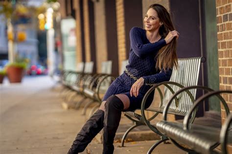 A Lovely Brunette Model Poses Outdoor While Enjoying The Fall Weather