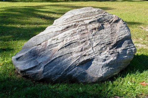 Large Boulder in Green Grass Field