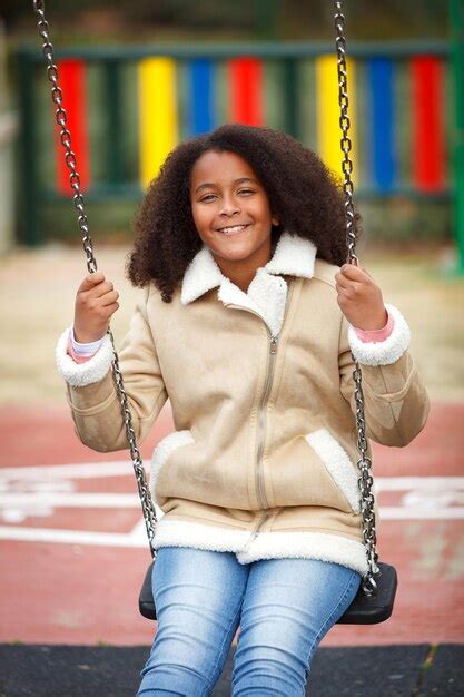 Premium Photo Portrait Of Smiling Young Woman On Swing In Playground