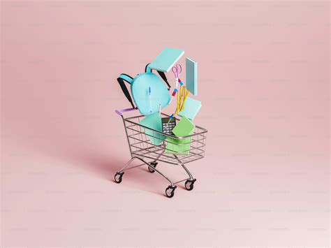 Shopping cart with school supplies falling inside it with pastel red