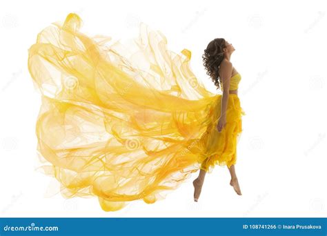 Flying Woman Levitation Jump Fashion Model In Fly Yellow Dress Stock