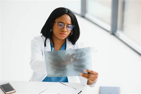 Young Professional African American Doctor Examining X Ray Of Patients