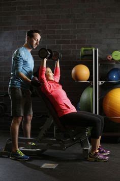 Kay gets a hand from Mike on the bench press in the Fitness Centre at ...