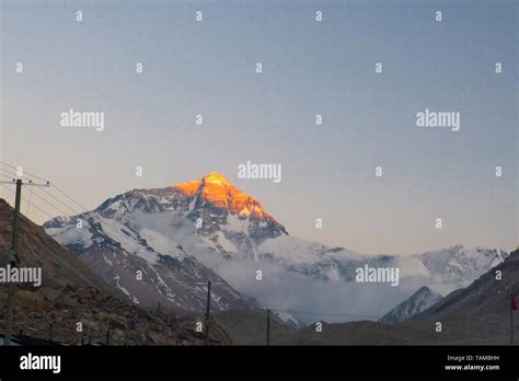 Morning sunrise at with an orange glow on the face of Mount Everest ...