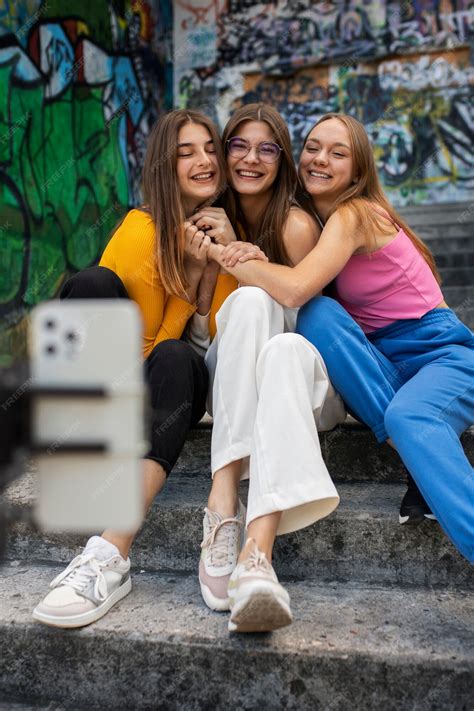 Free Photo | Young teenage girls recording reels of themselves outdoors ...