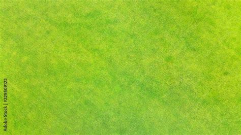 Aerial. Green grass texture background. View above from bird's eye view ...