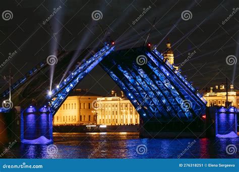 Raised Palace Bridge With Blue Illumination Over The Neva River In St