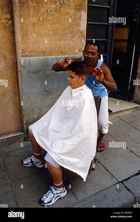 Cuban Hairdresser Cutting A Boys Hair On The Street La Habana Vieja