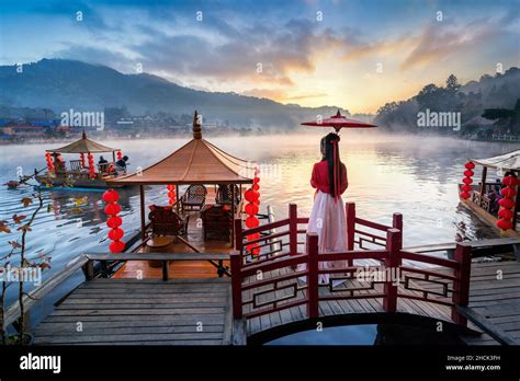 Asian Woman Wearing Chinese Traditional Dress At Ban Rak Thai Village