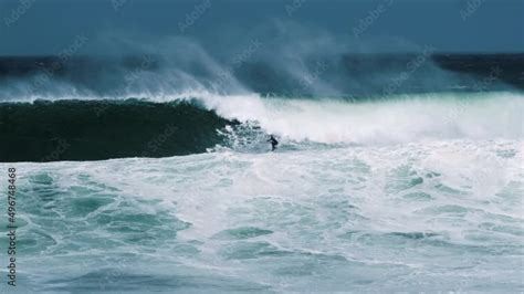 Big wave surfer riding a big wave Stock Video | Adobe Stock