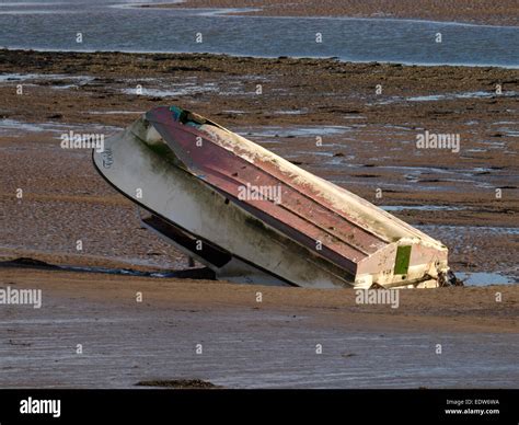 Upside Down Boat In The Mud Of The River Taw Estuary Devon Uk Stock