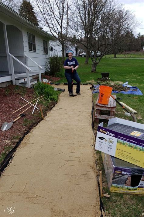 a person sitting on a sidewalk next to some boxes and other items in ...