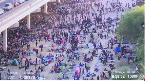 Drone Footage Emerges Showing Thousands Of Migrants Under A Bridge In