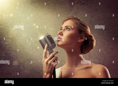 Attractive Female Singer With Microphone Stock Photo Alamy