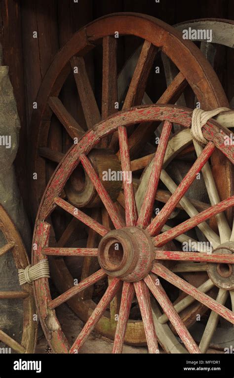 Collection of antique rustic farm wagon wheels Stock Photo - Alamy