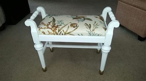 A White Chair With A Bird Print Seat Cover On It S Armrests