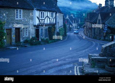 A Morris Minor Car Driving Through Castle Combe Village Wiltshire