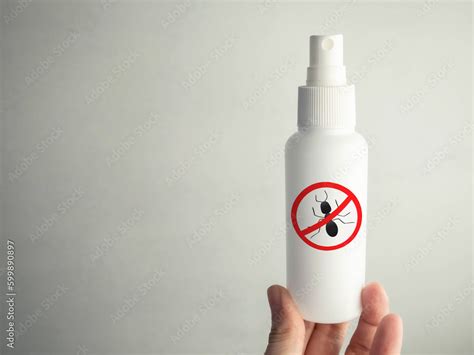 Spray against ants and insects. In the hand is an insecticide. Ant icon, warning sign. Insect ...