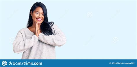 Hispanic Woman With Long Hair Wearing Casual Clothes Praying With Hands