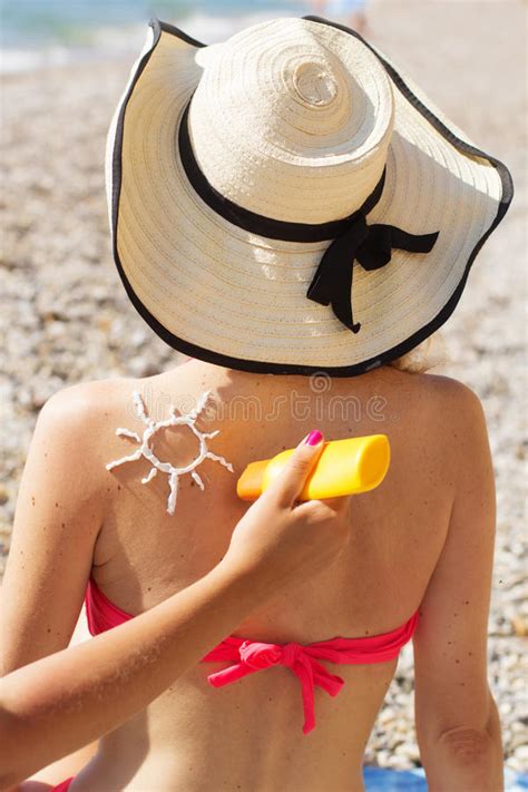 Friend Applying Sunscreen Lotion Over Tan Woman Stock Photo Image Of