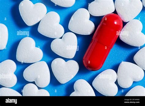 Heart Shaped Tablets And Red Pill On Blue Background Medicine