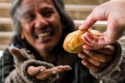 Hand Giving Bread Or Food To Blurred Happy Face Homeless Male Stock