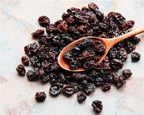 premium photo dried grapes raisins   grey concrete background