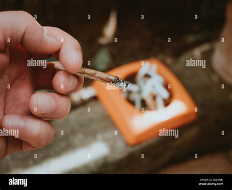 Hand Putting The Cigarette On An Ashtray Stock Photo Alamy