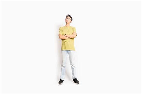 Premium Photo A Man In A Yellow Shirt Stands In Front Of A White