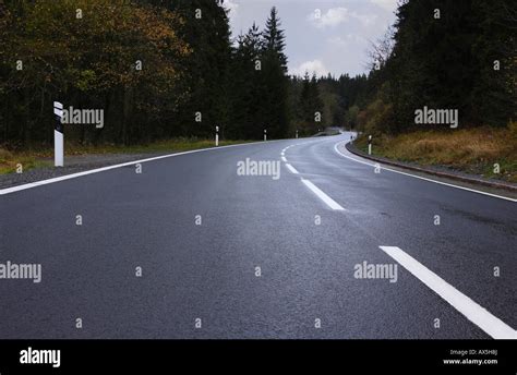 Winding road in a forest Stock Photo - Alamy